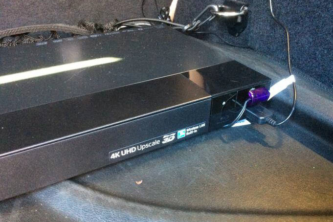 A Sony Blu-ray player in the trunk of a BMW X1